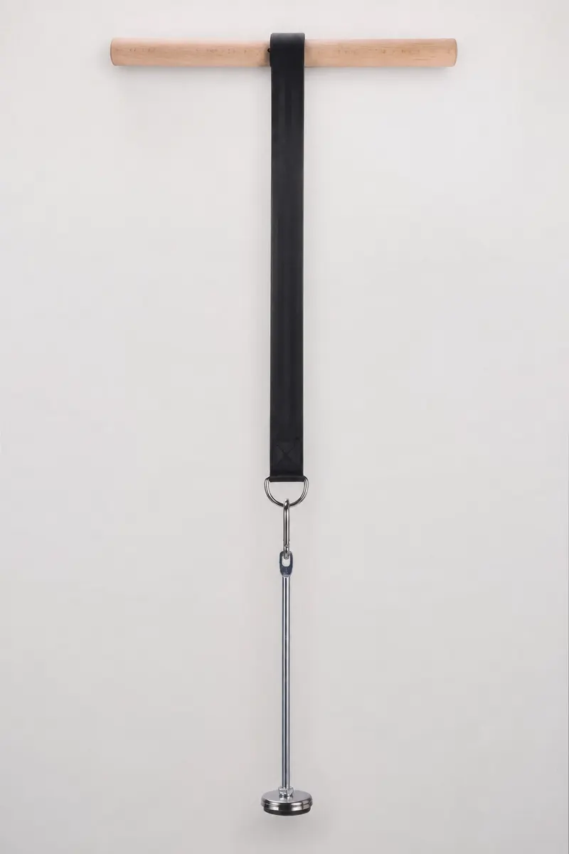 Wrist roller hanging vertically with the strap fully extended and a loading pin clipped to the carabiner